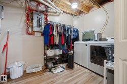 Dedicated laundry area with durable wood-finish flooring - 