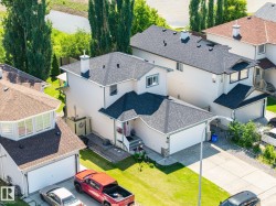 Residential property featuring a two-car garage, asphalt shingle roofing, and a concrete driveway - 
