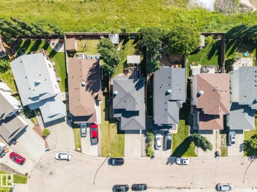 Aerial overview showcasing multiple properties with diverse rooflines and varying lot sizes - 60 Leyland Way, Spruce Grove, AB 