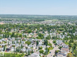 Expansive aerial perspective showcasing a residential neighborhood with numerous homes - 