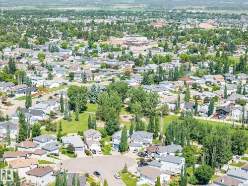 Aerial perspective of a residential neighborhood featuring numerous detached homes with varying rooflines and exterior finishes - 60 Leyland Way, Spruce Grove, AB 