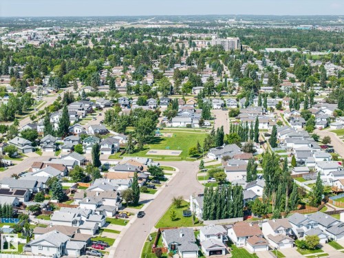 Aerial perspective showcasing a residential neighborhood with a central green space - 60 Leyland Way, Spruce Grove, AB 