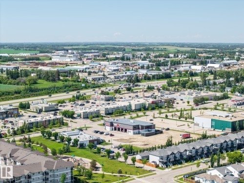 Expansive aerial perspective showcasing a mixed-use commercial and residential district - 60 Leyland Way, Spruce Grove, AB 