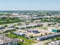 Expansive aerial perspective showcasing a mixed-use commercial and residential district - 