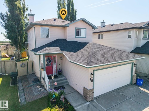 Two-story residence featuring light-toned siding and a dark shingle roof - 60 Leyland Way, Spruce Grove, AB 