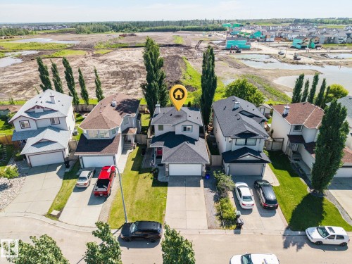 Two-story residence featuring a dark shingle roof and light-colored siding - 60 Leyland Way, Spruce Grove, AB 