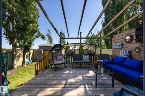 Expansive wood deck with a slatted pergola overhead - 60 Leyland Way, Spruce Grove, AB 