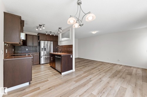 Open-concept kitchen and living area featuring wood-finish flooring - 12523 171 Avenue, Edmonton, AB 