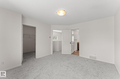 Spacious room featuring light gray carpet flooring and white painted walls - 12523 171 Avenue, Edmonton, AB 