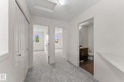 Upper-level hallway with light gray carpeting - 