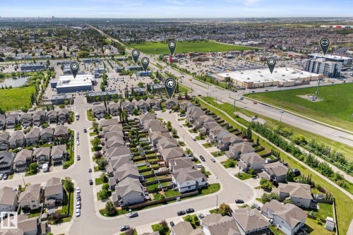 Aerial perspective showcasing a residential neighborhood with detached homes, featuring street parking and green spaces - 12523 171 Avenue, Edmonton, AB 