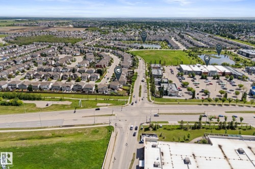 Aerial perspective showcasing a residential development with extensive green spaces and multiple bodies of water - 12523 171 Avenue, Edmonton, AB 