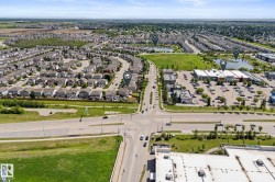 Aerial perspective showcasing a residential development with extensive green spaces and multiple bodies of water - 