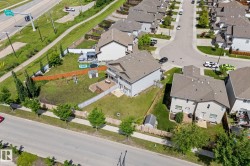 Expansive backyard featuring a partial wood fence, partial chain-link fence, and a small storage shed - 