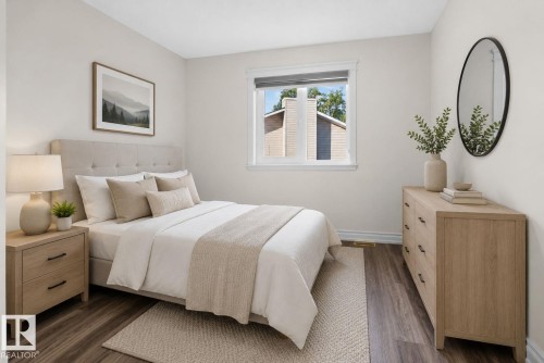 Bedroom featuring wood-finish flooring, a window with white trim, and light-toned walls - 4615 43A Avenue, Edmonton, AB - Indoor Photo Showing Bedroom