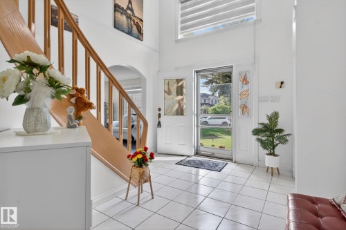 Entry foyer featuring tile flooring and a light wood staircase with balusters - 4615 43A Avenue, Edmonton, AB - Indoor Photo Showing Other Room