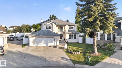Exterior featuring light-colored stucco, a multi-car driveway, a two-car attached garage, and a separate single-car attached garage - 4615 43A Avenue, Edmonton, AB - Outdoor