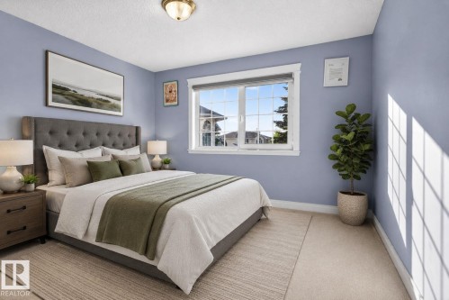 Bedroom featuring a window with grid pattern, light blue walls, and neutral carpet flooring - 4615 43A Avenue, Edmonton, AB - Indoor Photo Showing Bedroom