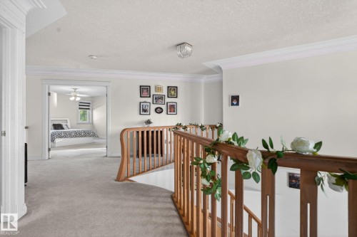 Second-story hallway featuring light-toned carpeting and white wall finishes - 4615 43A Avenue, Edmonton, AB - Indoor Photo Showing Other Room