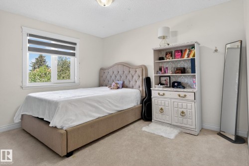 Carpeted room with a single window featuring horizontal blinds - 4615 43A Avenue, Edmonton, AB - Indoor Photo Showing Bedroom