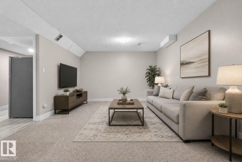 Carpeted living space featuring neutral wall tones - 4615 43A Avenue, Edmonton, AB - Indoor