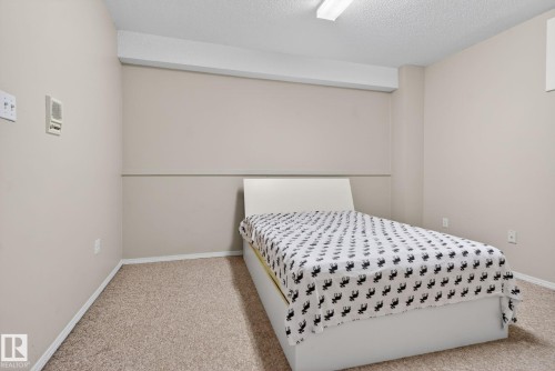 Neutral-toned walls complement the textured carpet flooring - 4615 43A Avenue, Edmonton, AB - Indoor Photo Showing Bedroom