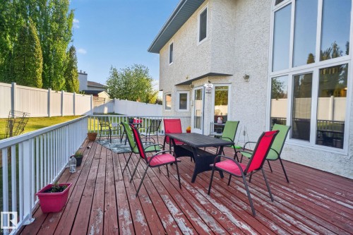 Expansive wood-finish deck with white railing system - 4615 43A Avenue, Edmonton, AB - Outdoor With Deck Patio Veranda With Exterior