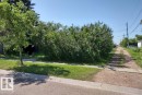 Spacious lot offering a paved road frontage, concrete sidewalk, and a gravel lane access - 4927 50 Ave, Chipman, AB 