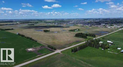 Expansive rural landscape featuring a mix of cultivated fields and wooded areas - 24209 Hwy 625, Beaumont, AB 