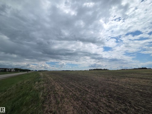 Expansive cleared land featuring cultivated earth and a grassy roadside verge - 24209 Hwy 625, Beaumont, AB 