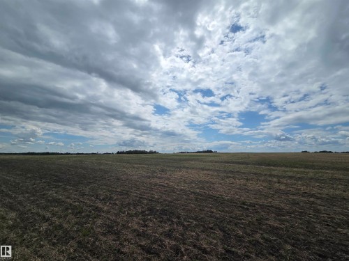 Expansive agricultural land featuring a clear horizon and open sky - 24209 Hwy 625, Beaumont, AB 