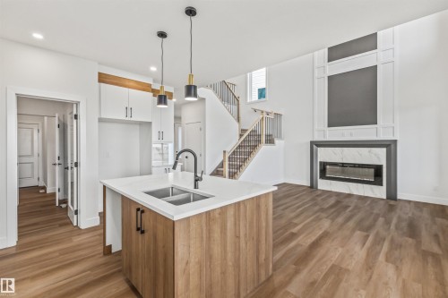 178 Elliott Wynd, Fort Saskatchewan, AB - Indoor Photo Showing Kitchen With Fireplace With Double Sink