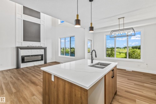 178 Elliott Wynd, Fort Saskatchewan, AB - Indoor Photo Showing Kitchen With Fireplace With Double Sink