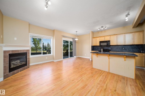 Open-concept living space with wood-finish flooring - 46 15151 43 Street, Edmonton, AB 
