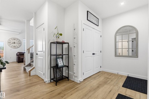 Entryway featuring light wood-finish flooring and bright white walls - 7 Tenor Link, Spruce Grove, AB 