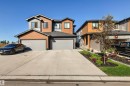 Modern two-story residence with a multi-tone facade, featuring horizontal wood-look siding and gray panels - 7 Tenor Link, Spruce Grove, AB 