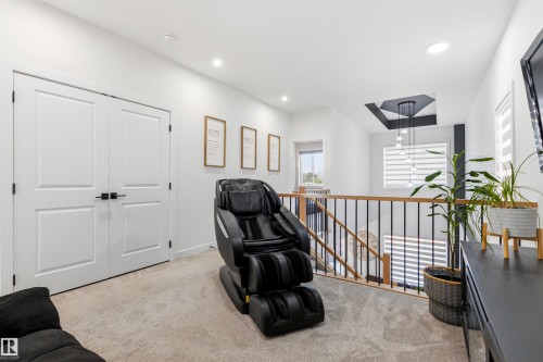 Carpeted landing with white walls and recessed lighting - 7 Tenor Link, Spruce Grove, AB 
