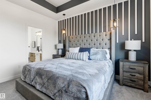 Tray ceiling with dark accent paint, gray textured carpet, and a decorative accent wall featuring vertical white strips - 7 Tenor Link, Spruce Grove, AB 