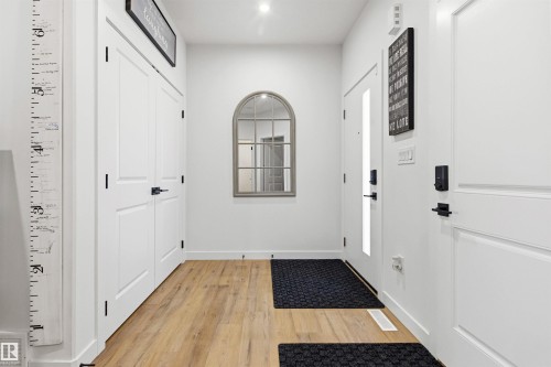Entryway featuring light wood-finish flooring and crisp white walls - 7 Tenor Link, Spruce Grove, AB 
