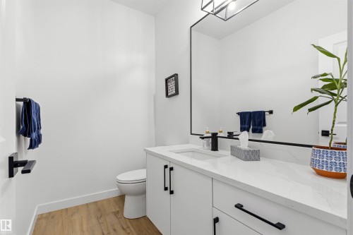 White vanity with a single integrated sink, stone-look countertop, and modern black faucet - 7 Tenor Link, Spruce Grove, AB 