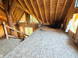 Exposed wood beam construction with a log cabin wall system - 