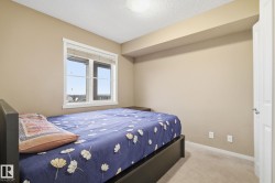 Room featuring a window with white trim, beige wall paint, light-colored carpet, and a white interior door - 