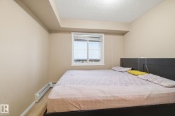 Bedroom featuring neutral-toned walls, white trim, and carpet flooring - 
