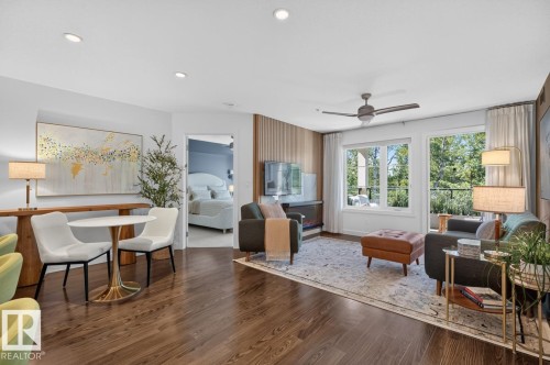 Open-concept living area featuring rich wood-finish flooring and recessed lighting - 207 5025 Edgemont Boulevard, Edmonton, AB 