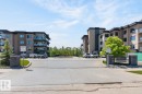 Modern multi-story buildings featuring balconies with glass railings - 207 5025 Edgemont Boulevard, Edmonton, AB 