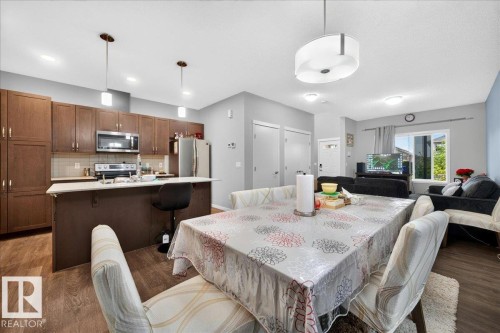 Open-concept living area featuring wood-finish flooring - 1187 Cy Becker Road, Edmonton, AB 