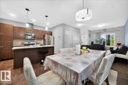 Open-concept living area featuring wood-finish flooring - 