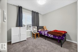 Neutral-toned wall paint and carpet flooring create a cohesive aesthetic in this room - 