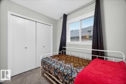 Room featuring light gray walls, gray carpet flooring, and a white bi-fold closet - 