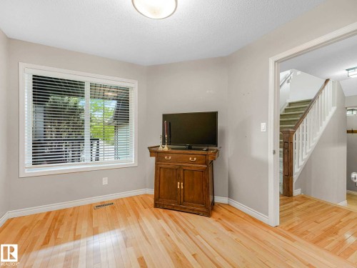 Bright interior with wood-finish flooring, white trim, and a flush mount ceiling light - 1325 Latta Crescent, Edmonton, AB - Indoor Photo Showing Other Room